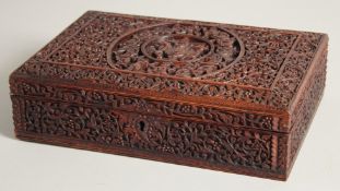 AN INDIAN CARVED WOOD BOX, with hinged lid, key included, 27.5cm x 18.5cm.