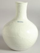 A CHINESE WHITE GLAZE CARVED FLOWER VASE, bearing four-character mark, 28.5cm high.