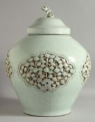 A LARGE CHINESE YUAN STYLE URN AND COVER, with relief floral panels and incised decoration, the