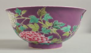 A CHINESE PURPLE GROUND FAMILLE ROSE BOWL, with enamel painted floral decoration, character mark