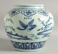 A LARGE CHINESE BLUE AND WHITE PORCELAIN JARDINIERE, painted with birds and flora, bearing a four-