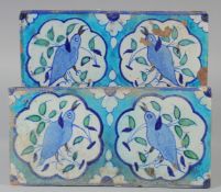 A PAIR OF 19TH CENTURY INDIAN MULTAN TILES, decorated with birds, each approx. 30cm x 15cm.