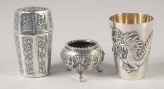 THREE ORIENTAL SILVER ITEMS; a dragon goblet, a octagonal container and a miniature tripod bowl,