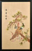 A PAIR OF CHINESE TEXTILES, depicting cranes and peacocks, framed and glazed, textiles 59.5cm x 34.
