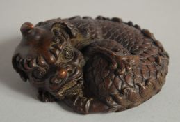 A JAPANESE BRONZE OKIMONO KYLIN, 8cm wide.