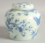 A CHINESE BLUE AND WHITE PORCELAIN JAR AND COVER, with birds and flora, 13cm high.