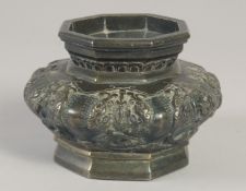 A CHINESE BRONZE OCTAGONAL CENSER, with panels of relief decoration, 13.5cm wide.