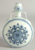 A CHINESE BLUE AND WHITE PORCELAIN TWIN HANDLE MOON FLASK, with central yin-yang medallion radiating