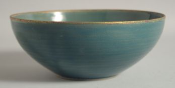 A CHINESE CELADON BOWL, with incised gilt characters, 22cm diameter.