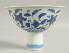 A CHINESE BLUE AND WHITE PORCELAIN STEM CUP, with floral decoration, bowl 15cm diameter.