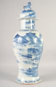 A LARGE CHINESE BLUE AND WHITE PORCELAIN VASE AND COVER, painted with an ox crossing a bridge within