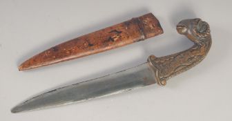 A 19TH CENTURY PERSIAN QAJAR DAGGER, with ram's head handle and leather overlaid wooden scabbard,