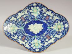 A 19TH CENTURY CHINESE BLUE GROUND QUATREFOIL FORM DISH, decorated with foliate motifs, red