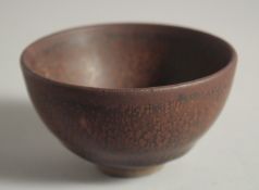 A CHINESE JIAN WARE TEA CUP, with character mark to base, 9cm diameter.