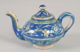 A PALISTINIAN GLAZED POTTERY TEAPOT, with foliate decoration, 19cm spout to handle.
