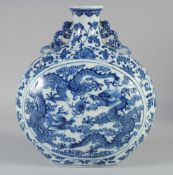 A CHINESE BLUE AND WHITE PORCELAIN MOON FLASK VASE, decorated with dragons and the flaming pearl