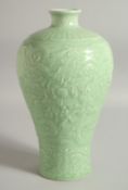 A RARE CHINESE CELADON GLAZE CARVED DRAGON VASE, the relief decoration with dragons surrounding