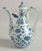 A CHINESE MING STYLE BLUE AND WHITE PORCELAIN LIDDED WINE POT, with floral decoration, 30cm high.