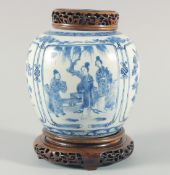 A CHINESE BLUE AND WHITE PORCELAIN JAR, with a carved and pierced cover and stand, the jar painted