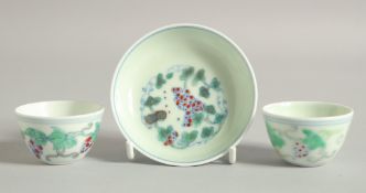 TWO CHINESE DOUCAI PORCELAIN CUPS AND A SAUCER, each similarly decorated with grapes, saucer 8cm