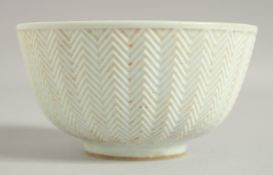 A CHINESE MING STYLE BLUE AND WHITE RICE BOWL, painted with fish and with carved exterior, 12cm