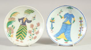 TWO TURKISH KUTAHYA GLAZED POTTERY DISHES, each painted with a figure, both 14cm diameter, (2).