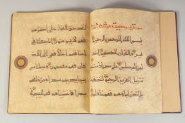 A 20TH CENTURY EASTERN BOUND KUFIC SCRIPT JUZ FROM THE QURAN, 30cm x 25cm.