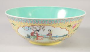 A CHINESE YELLOW GROUND FAMILLE ROSE PORCELAIN BOWL, with panels of female figures and further