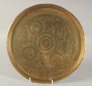 AN ENGRAVED AND CHASED BRASS DISH, with animals and flora, 29.5cm diameter.
