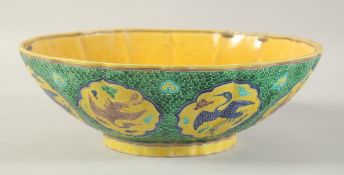 A CHINESE FAHUA PORCELAIN BOWL, decorated with panels of cranes, 28cm diameter, (af).