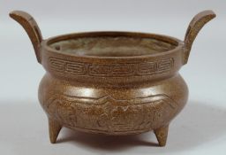 A CHINESE TWIN HANDLED CIRCULAR BRONZE CENSER. 5.5ins diameter.
