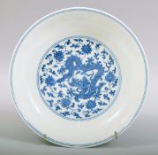 A GOOD CHINESE BLUE AND WHITE PORCELAIN DISH, the centre painted with a dragon amongst lotus and