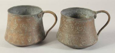 TWO ENGRAVED COPPER TANKARDS.