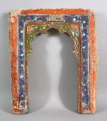 A 19TH CENTURY ISLAMIC INDIAN MIHRAB SHAPED POTTERY TILE, with polychrome decoration, 43.5cm high