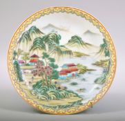 A CHINESE FAMILLE VERTE PORCELAIN DISH, the dish painted with a landscape scene with buildings and