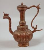 AN ISLAMIC BRONZE EWER. 9ins high.