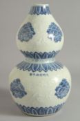 A CHINESE BLUE AND WHITE DOUBLE GOURD VASE decorated with flower heads and carved mice, with six-