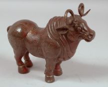 A CHINESE BRONZE STANDING BULL. 9ins long.