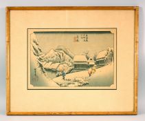 A JAPANESE WOODBLOCK PRINT of a snowy landscape, depicting figures, signed and sealed, 52cm x 42cm.