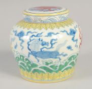 A CHINESE DOUCAI PORCELAIN JAR AND COVER, painted with mythical horses, 12.5cm high.