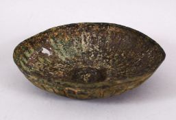 AN EARLY METAL MOULDED DISH in the Sassanian style, possibly Roman, 20cm diameter