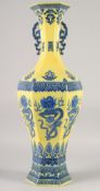 A LARGE CHINESE YELLOW GROUND BLUE AND WHITE HEXAGONAL VASE, with molded twin handles, 58cm high.