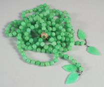 A DOUBLE ROW OF JADE BEADS with gold clasp. Approx 250 beads.