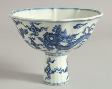 A CHINESE BLUE AND WHITE PORCELAIN PETAL FORM STEM CUP decorated with dragons. Cup 16cm wide.