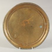 AN ENGRAVED BRASS DISH, with floral decoration, 29.5cm diameter.