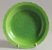 A CHINESE GREEN GLAZE PORCELAIN DISH, with incised dragon to the centre, character mark to base.