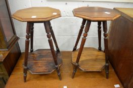A pair of small walnut two tier occasional tables.