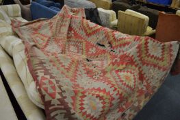 A large Kilim rug, worn 300cm x 166cm.