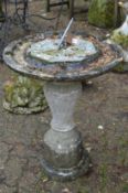 A composite garden sun dial.