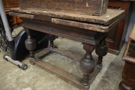 An Elizabethan style oak drawleaf dining table.